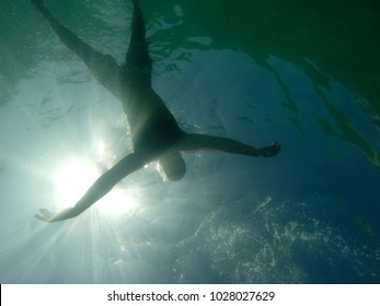 Man drowning viewed from below underwater