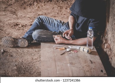 Man drugs addicted injecting heroin in his arm, Drug addict man with syringe using drugs, Drugs concept, 26 June, International Day Against Drug abuse. 