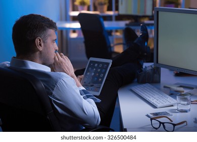 Man During Night Shift In Office Thinking About New Idea