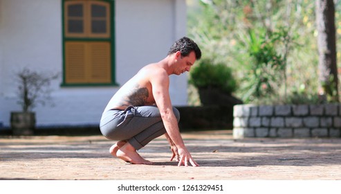 Man Dusting Off Hands By Cleaning With Pants, Preparing To Exercise