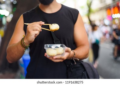 Man Eating Baozi On The Street In China