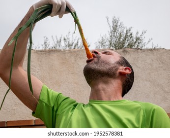 Man Eating Barbecue Of Spring Onion Shoots With Tomato Sauce, Typical Spanish Product Of The Region Of Catalonia