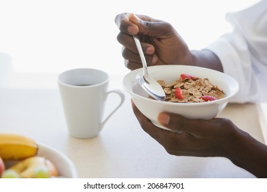 Man Eating Bowl Of Cereal Outside On A Sunny Day