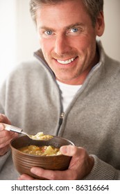 Man Eating Bowl Of Soup