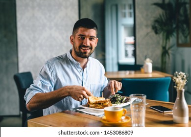 Man Eating Breakfast In Cafe