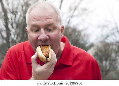 Man Eating Chili Cheese Dog