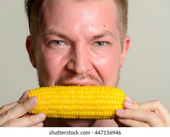 Man eating corn