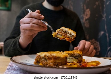 Man Eating Delicious Lasagna In A Restaurant