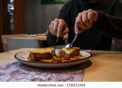 Man Eating Delicious Lasagna In A Restaurant