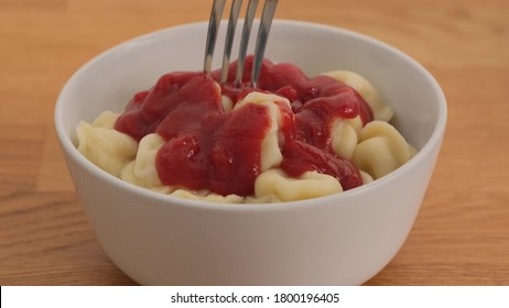 Man Eating Dumplings With Ketchup A Fork. Close Up