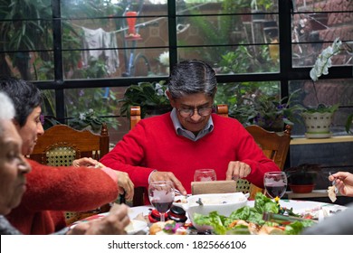 Man Eating At A Family Dinner For Christmas