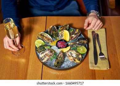 Man Eating Oysters At The Table