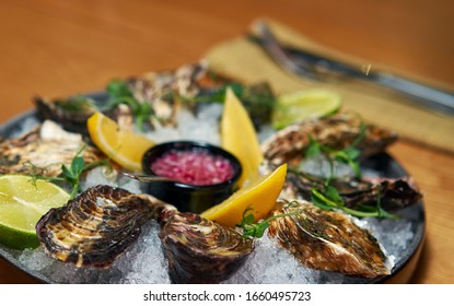 Man Eating Oysters At The Table