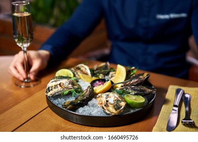 Man Eating Oysters At The Table