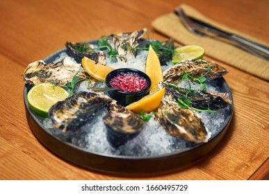 Man Eating Oysters At The Table