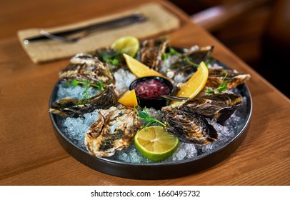 Man Eating Oysters At The Table