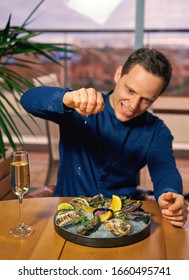 Man Eating Oysters At The Table