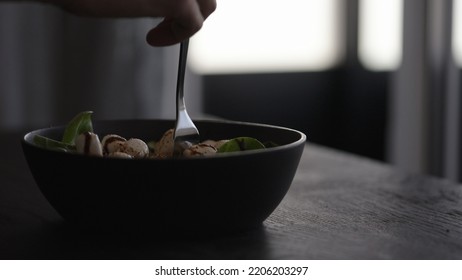 Man Eating Salad In Black Bowl, Wide Photo