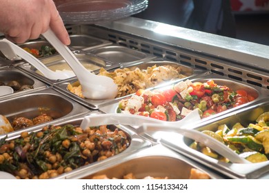 Man eating salad from canteen self-service buffet during lunch break