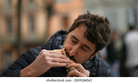 Man Eating Sandwich Outside Feeling Pleasure. Person Eat Food Snack Outdoors