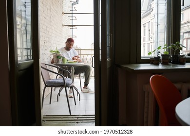 Man Eating Scrambled Eggs And Toasts With Concentration During The Breakfast