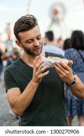 Man Eating Street Food. Street Hotdogs