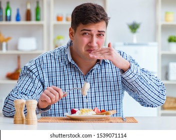 Man Eating Tasteless Food At Home For Lunch