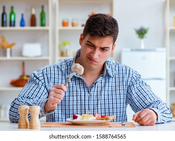 Man Eating Tasteless Food At Home For Lunch