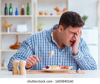 Man Eating Tasteless Food At Home For Lunch