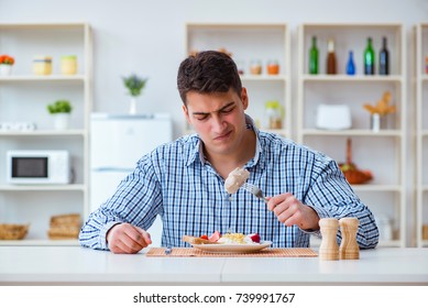 Man Eating Tasteless Food At Home For Lunch