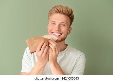 Man Eating Tasty Taco On Color Background