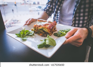 Man Eating Vegetarian Lasagna