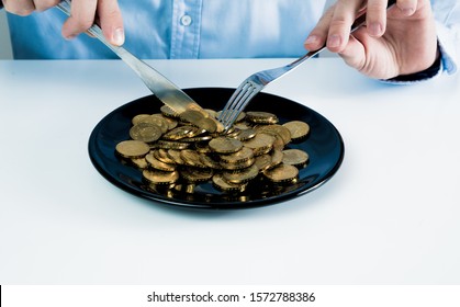 The Man Eats Gold Coins. Business And Financial Concept. Eating Money, Wealth. The Problem Of Excess Money.