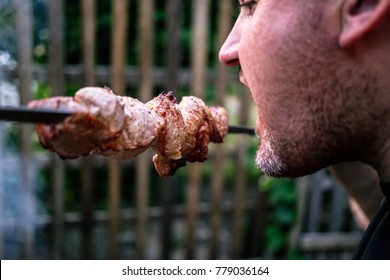 The Man Eats Shish Kebab On The Skewer