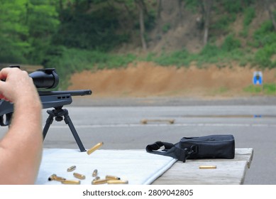 Man ejects spent shell from his rifle at the gun range