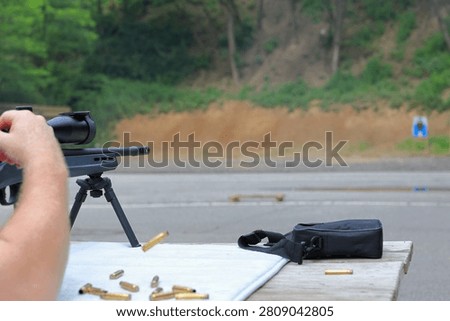 Man ejects spent shell from his rifle at the gun range