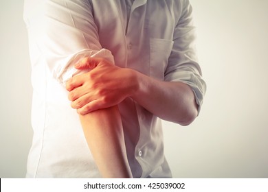 man elbow pain - Shutterstock ID 425039002