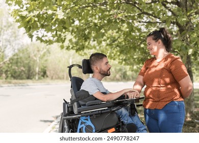 Man, an electric wheelchair user in the warm embrace of his wife, a couple enjoying and showing their affection. Disability and love concept. - Powered by Shutterstock