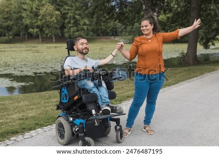 Similar – Image, Stock Photo Joyful wheelchair user with assistant enjoying outdoors