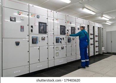 Man is in electrical energy distribution substation