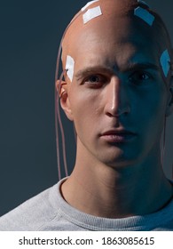 man with electrodes in his head is a futuristic concept of virtual reality and mind control. Neuro interface, contact of biological and mechanical. new kind of man, intellectual superiority