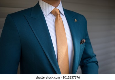 Man In Elegant Custom Tailored Expensive Suit Posing In Front Of Background  