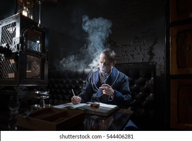 Man In An Elegant Robe Smoking A Cigar And Drinking Alcohol