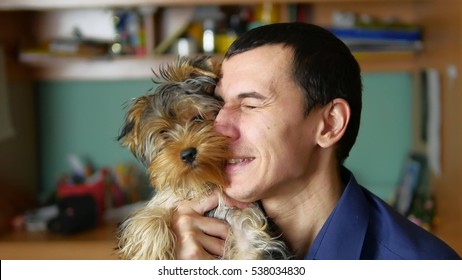 Man Embraces And Kisses A Dog Pet Friendship Indoor