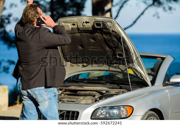 A man emotional calls for help to repair the\
breakdown the car