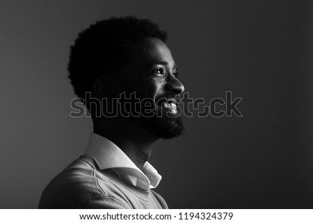 Similar – Image, Stock Photo Dramatic portrait of Black adult man looking up into spotlight while standing on stage in theater with low light copy space