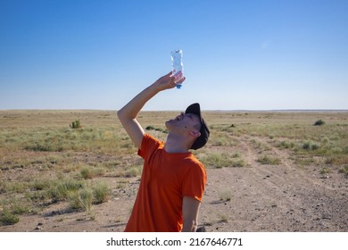 A Man With An Empty Bottle In The Desert. Thirst. Danger Of Dehydration. Out Of Water