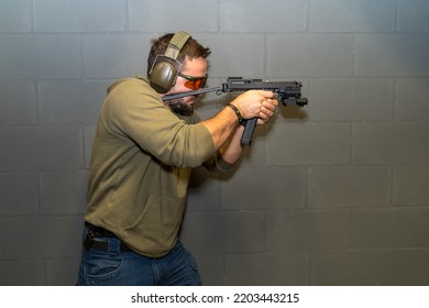 A Man Is Engaged In Tactical Shooting From A Pistol In A Shooting Range.