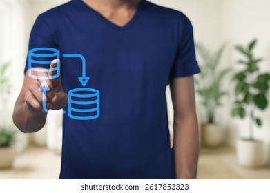 A man engages with digital data management concepts in a modern office. His interactive hand gesture illustrates data transfer and workflow efficiency.