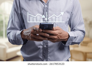 A man engages with his smartphone while a graph overlay indicates trends and metrics in a bright, modern office, symbolizing data-driven decision making. - Powered by Shutterstock - Get 15% off with code: PIKWIZARD15
